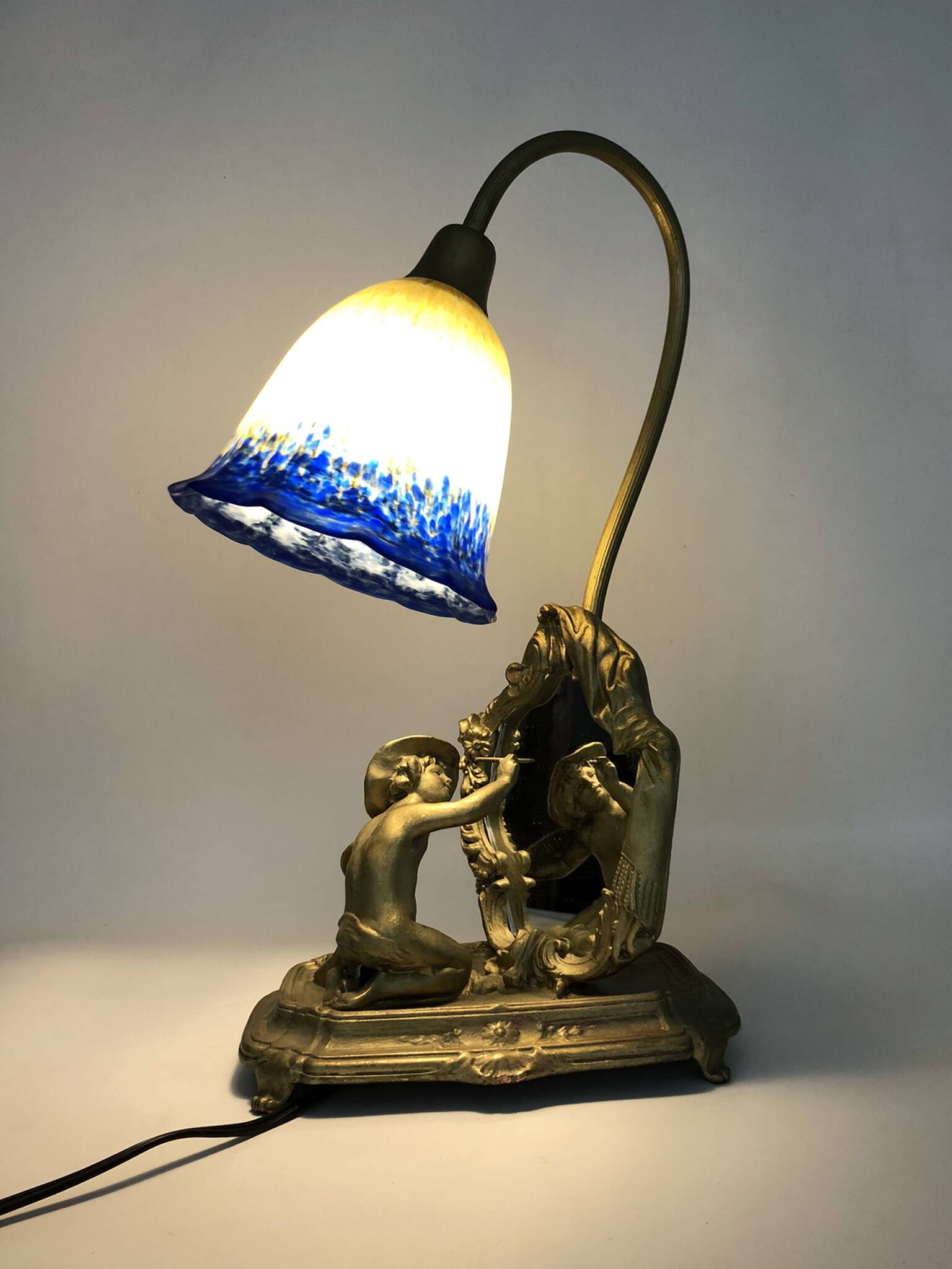 Vintage bronze table lamp featuring a painter on a mirror from the 1960s.