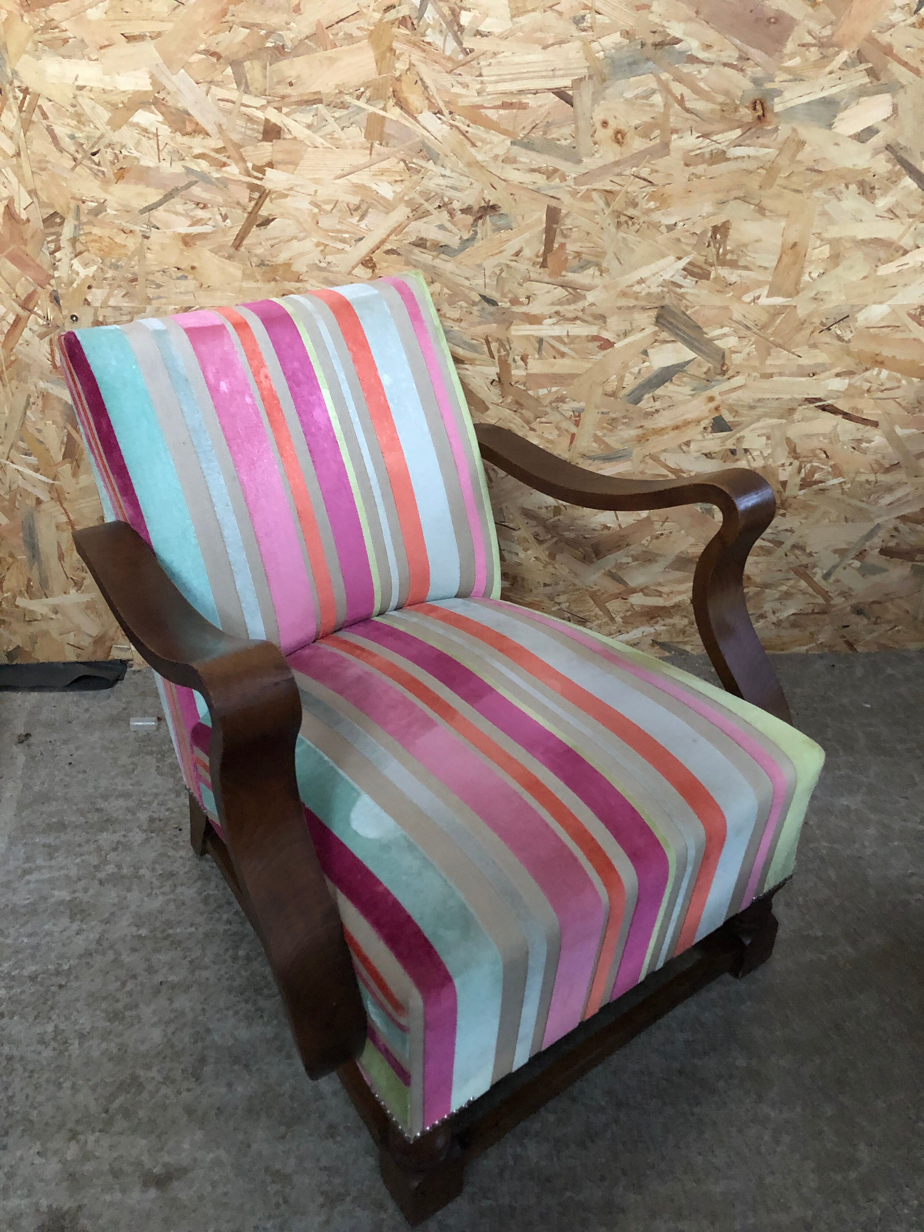 Old wooden armchair with curved armrests