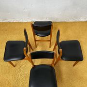 4 Scandinavian chairs in teak and black faux leather.