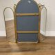 Vintage triptych mirror in brass with wall lights.