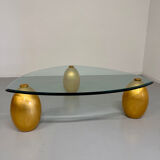 Vintage Italian design coffee table with a glass top and gold base, dating from the 1980s.