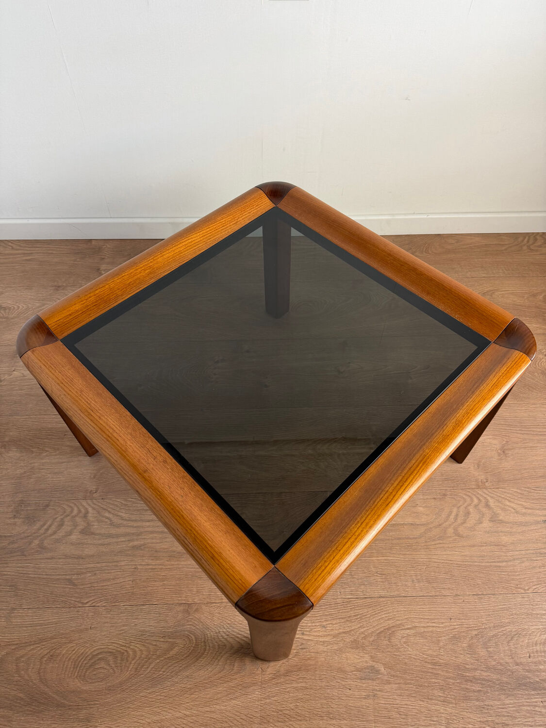 Square wooden coffee table with glass.