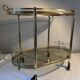 Neoclassical bar cart in gilded brass and smoked glass