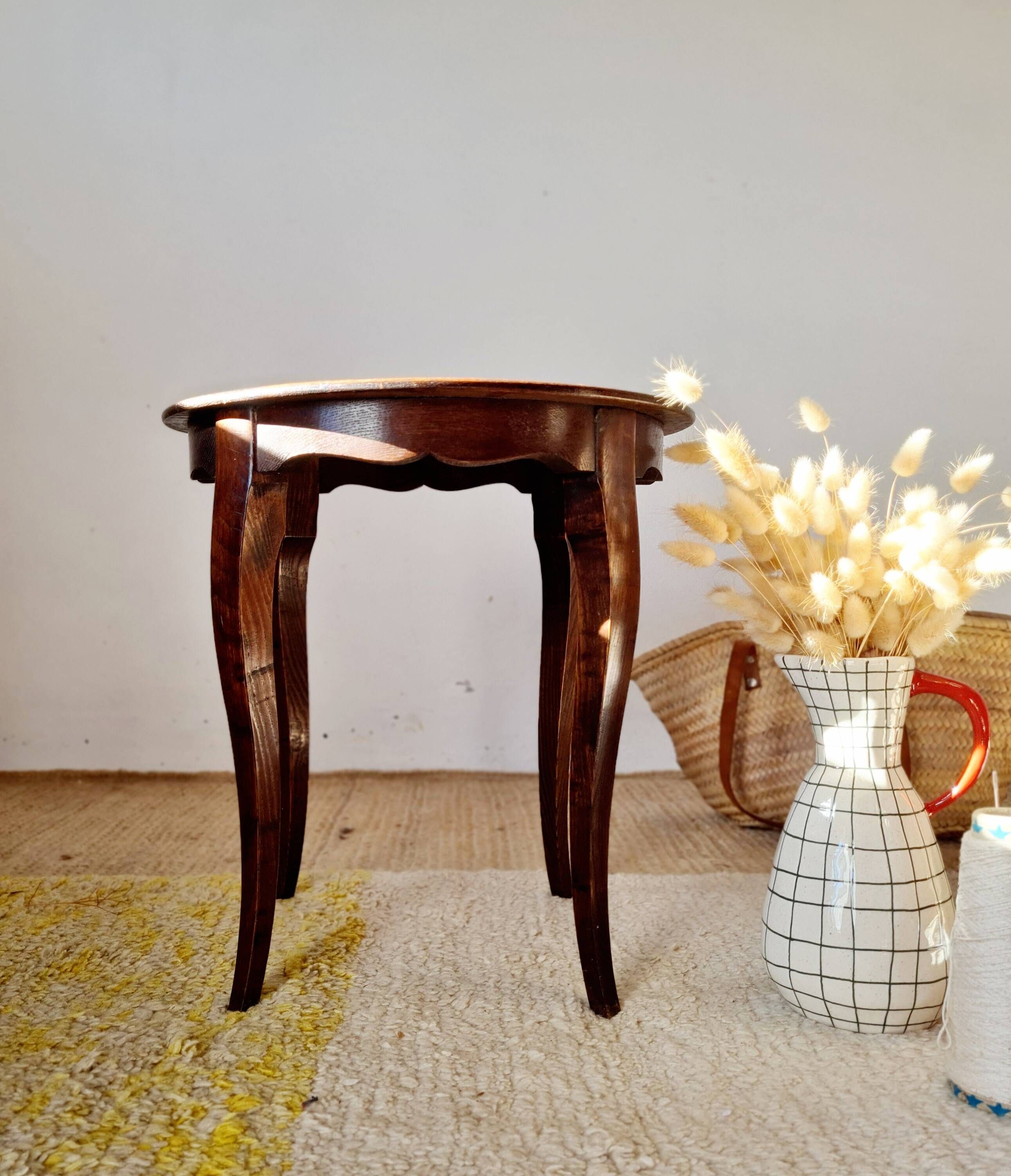 Vintage solid wood side table with curved legs.