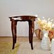 Vintage solid wood side table with curved legs.