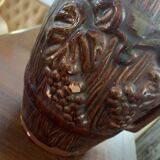 Hungarian folk ceramic pitcher with a brown glossy finish and relief decoration of vine.