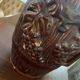 Hungarian folk ceramic pitcher with a brown glossy finish and relief decoration of vine.