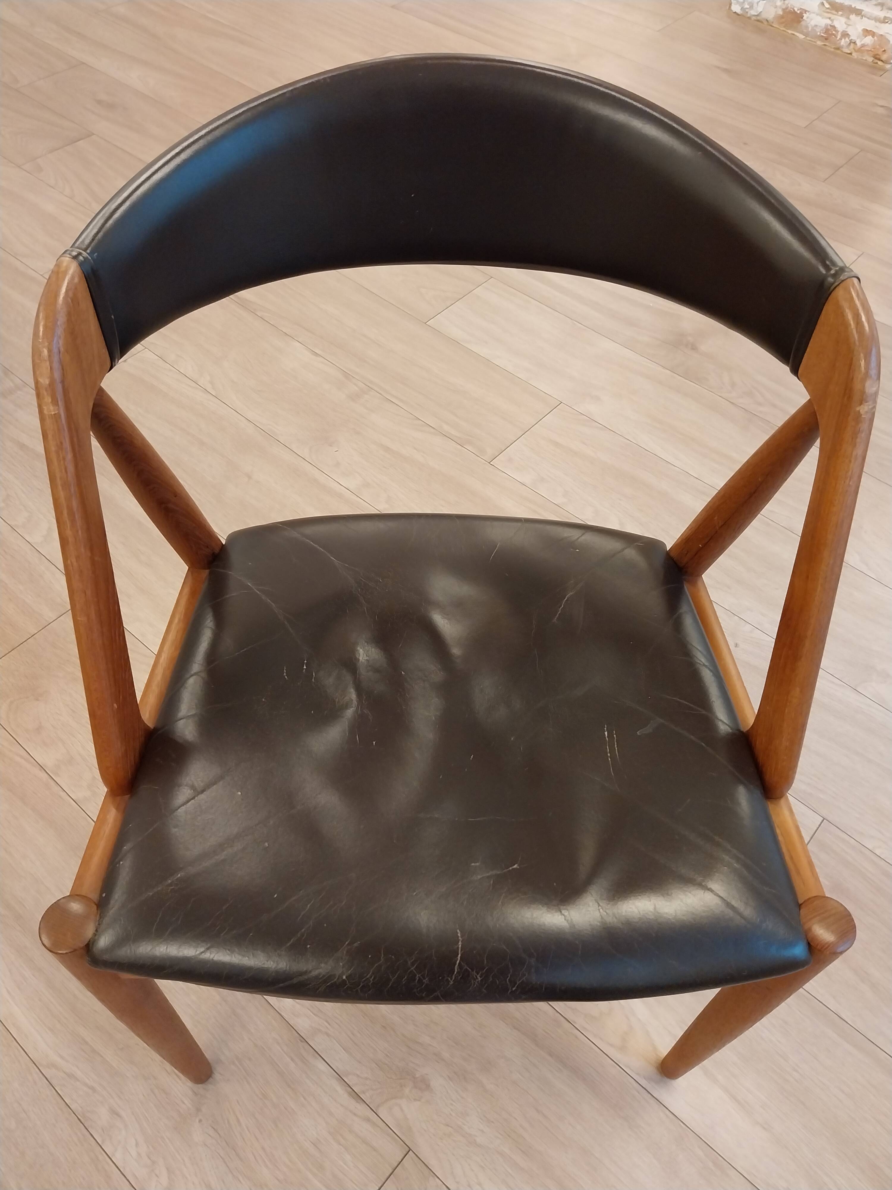Set of 6 vintage Kai Kristiansen chairs in solid teak and black faux leather.