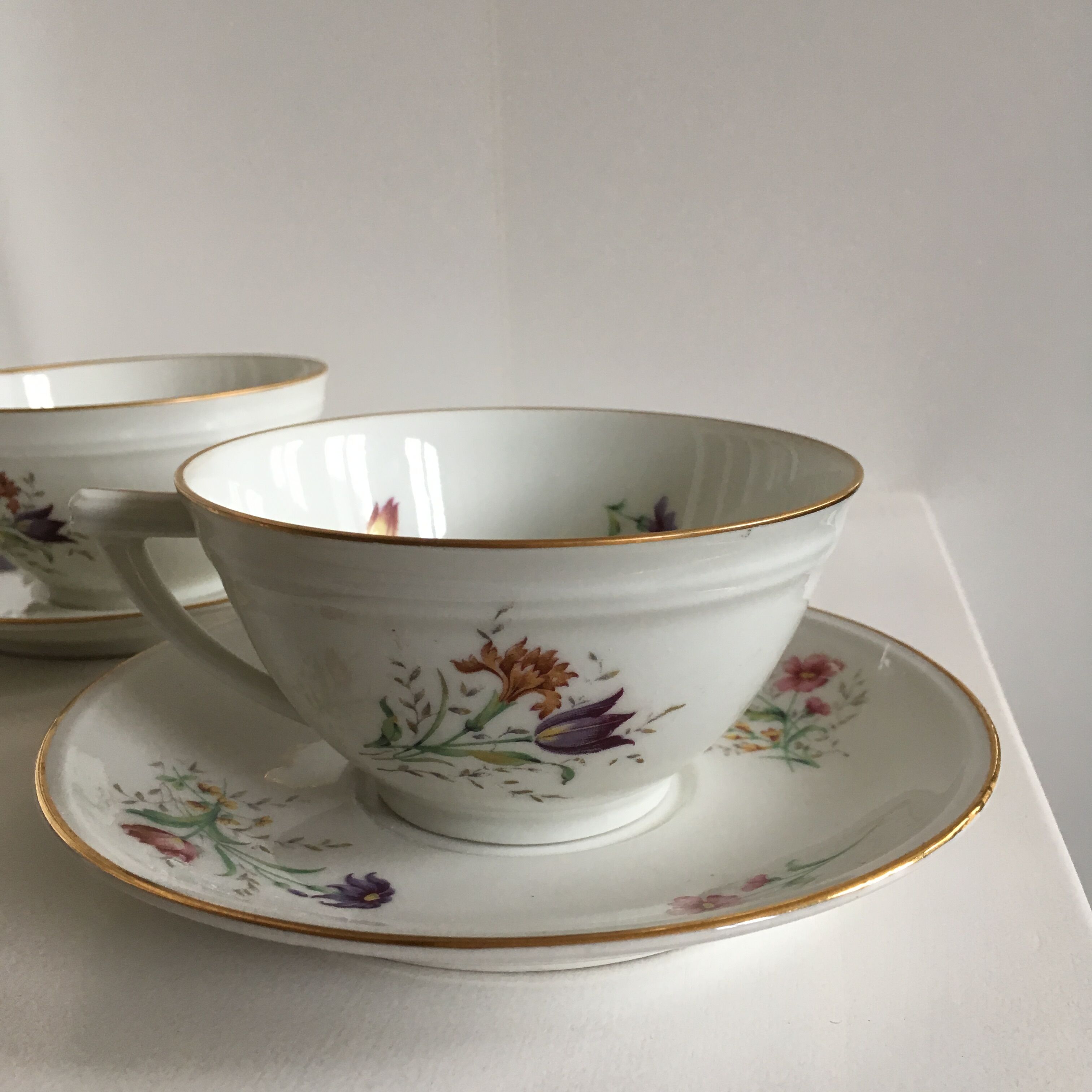 Duo of white Limoges porcelain cups with flowers