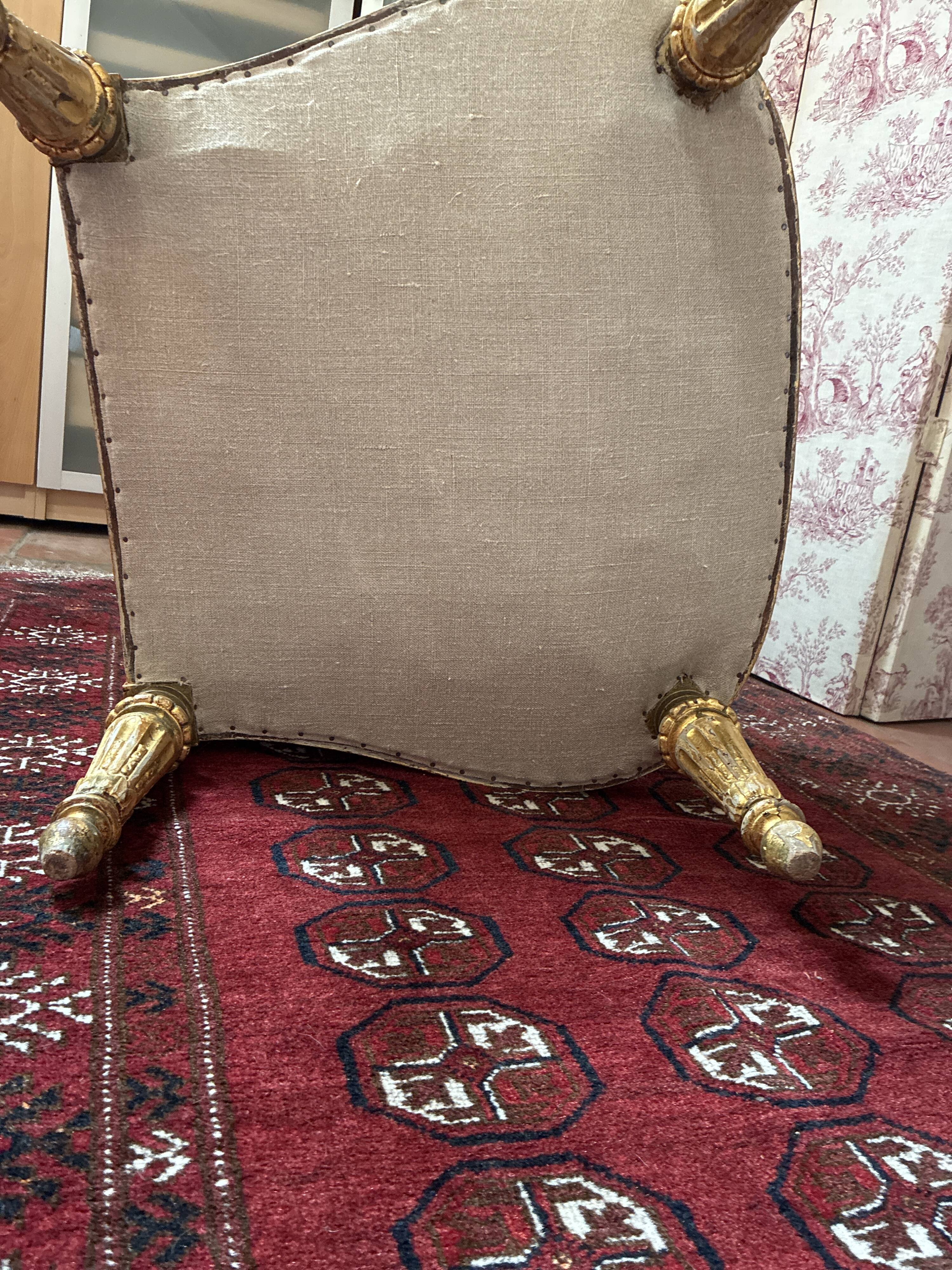 Large cabriolet armchair in Louis XVI style with gilded wood.