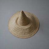 Hand-woven wicker straw hat, artisanal production, decorative object, bohemian ethnic countryside
