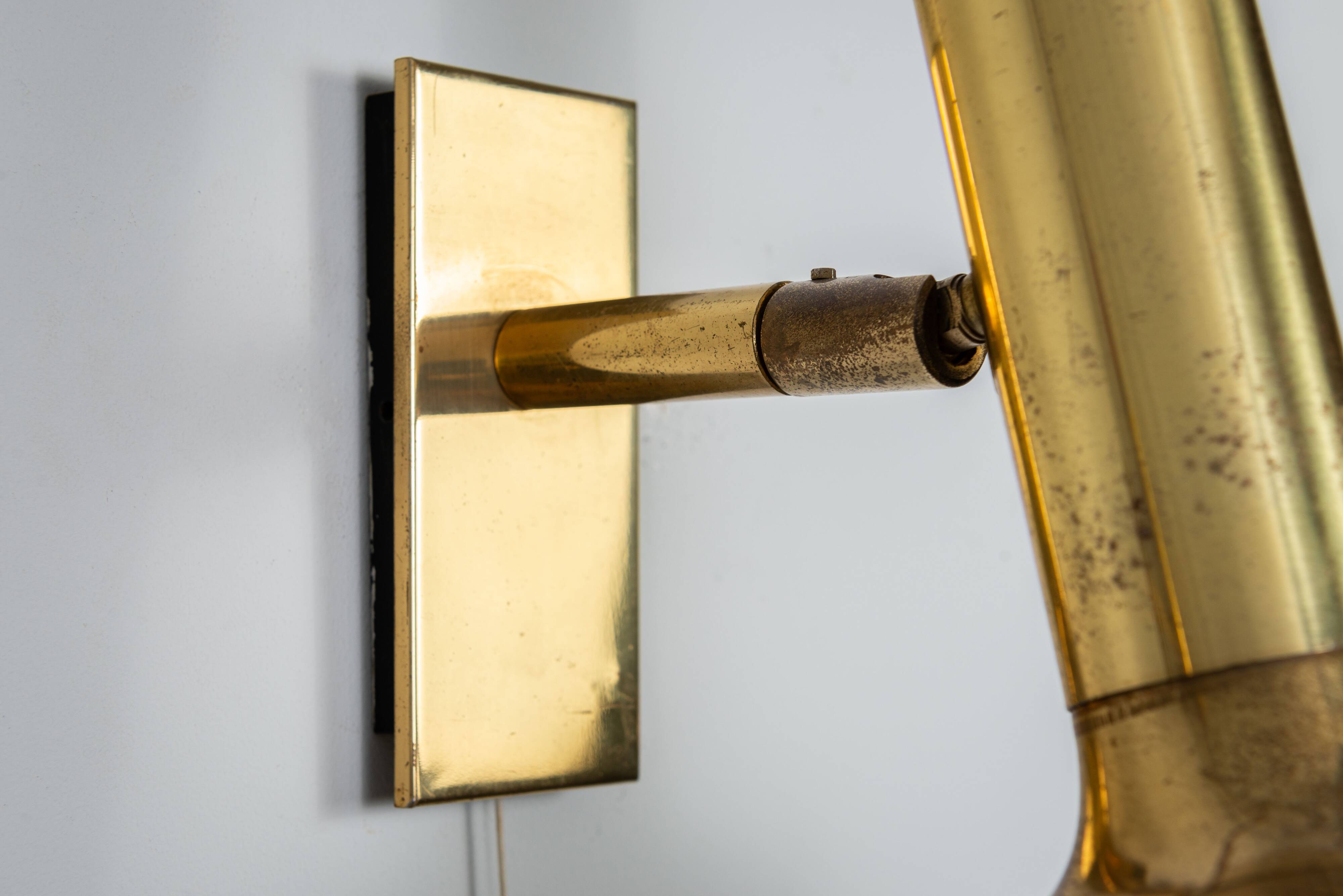 Set of three brass adjustable wall lamps