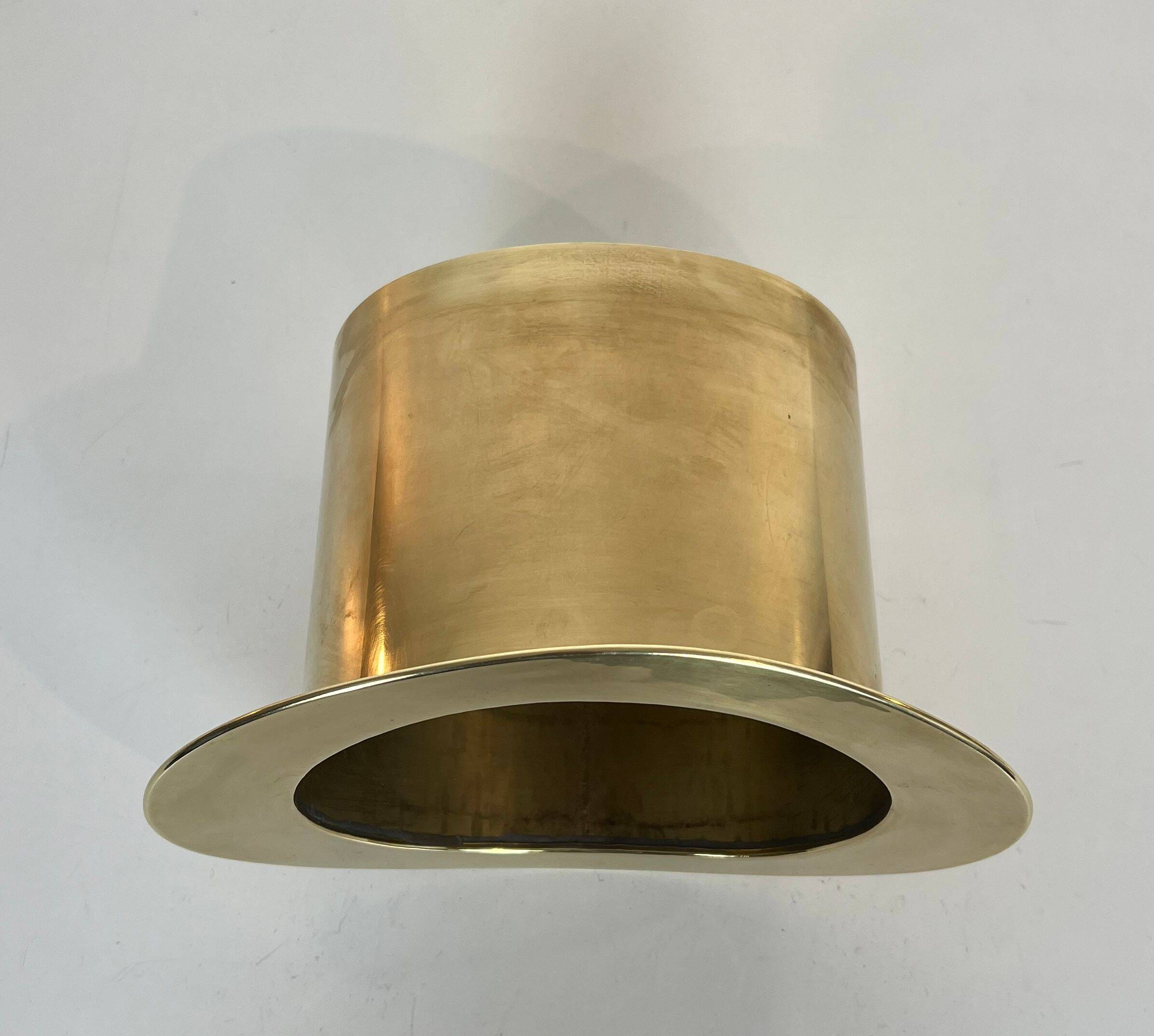 Champagne cooler shaped like a brass top hat.