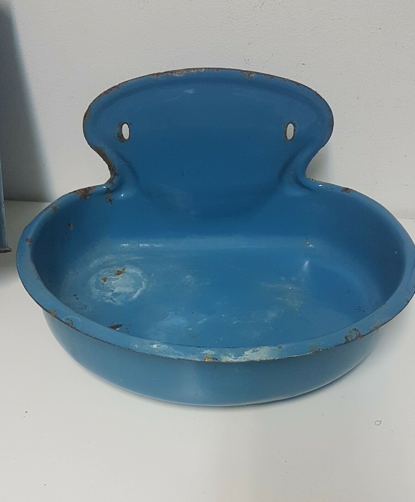 Old hands wash in enamelled sheet metal