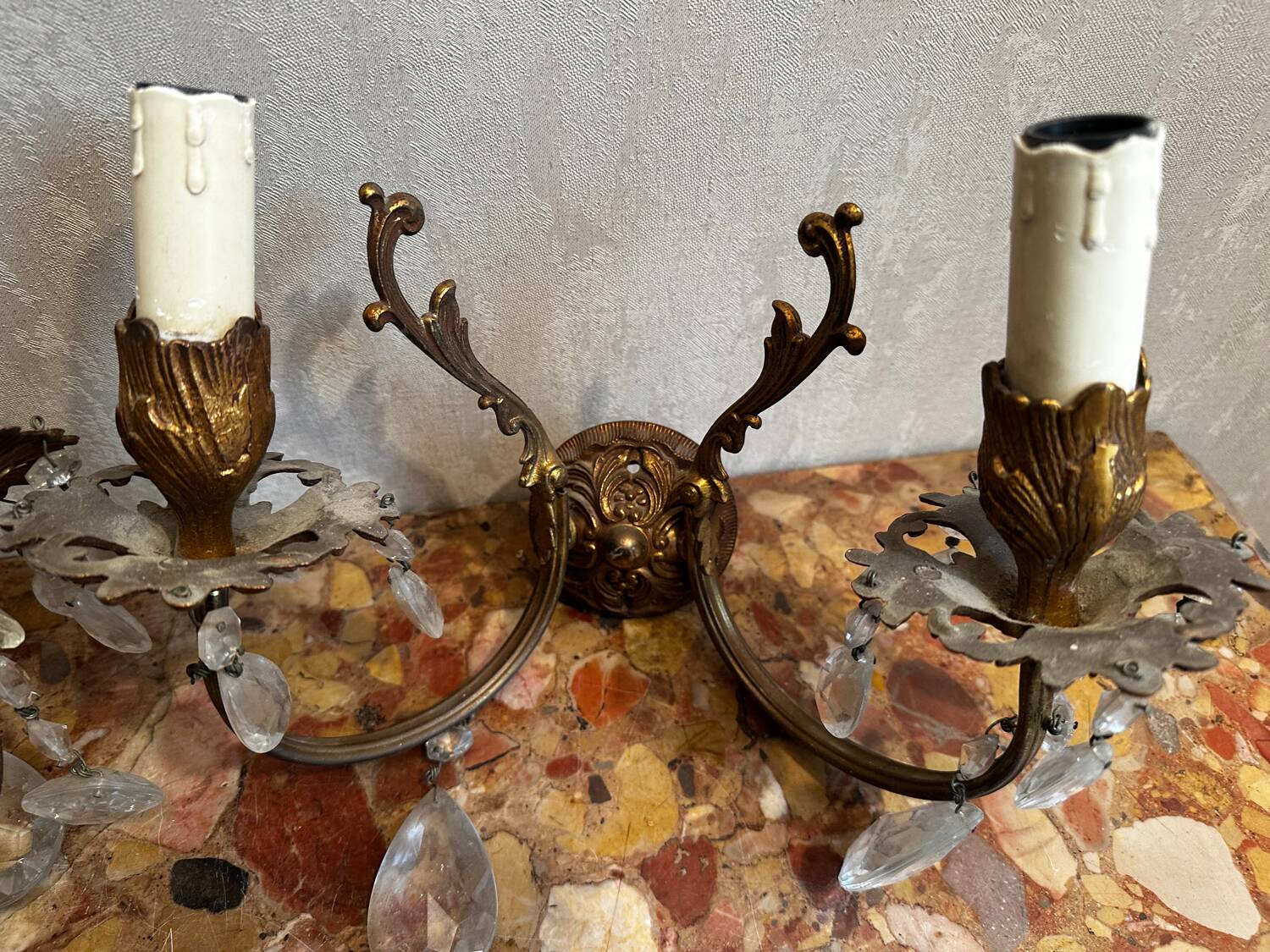 Pair of Louis XV style wall sconces in gilded bronze with glass pendants.