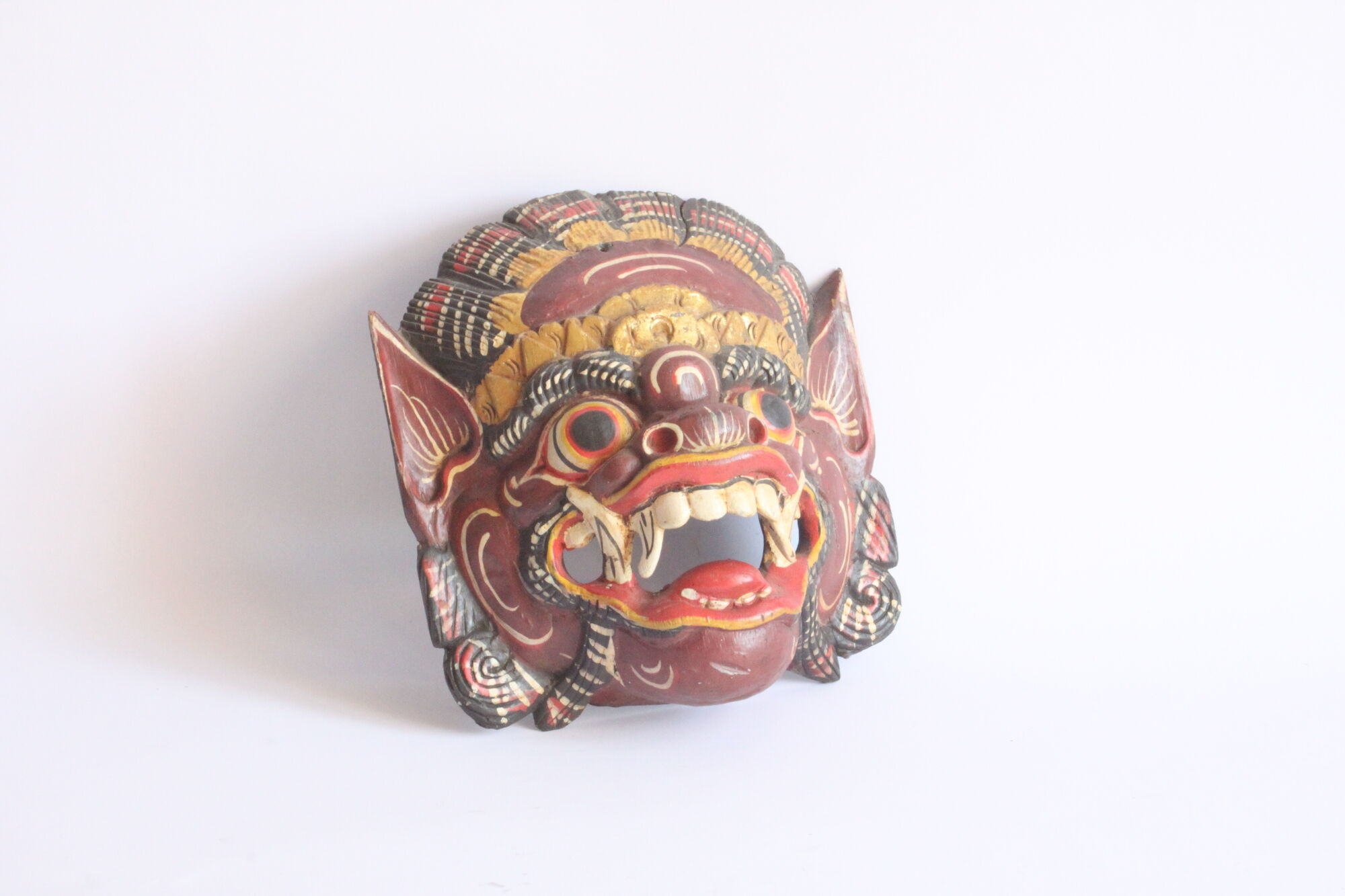 Two polychrome painted and gold leaf gilded Barong dance masks from Bali, Indonesia.