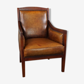 Armchair in sheepskin with wood