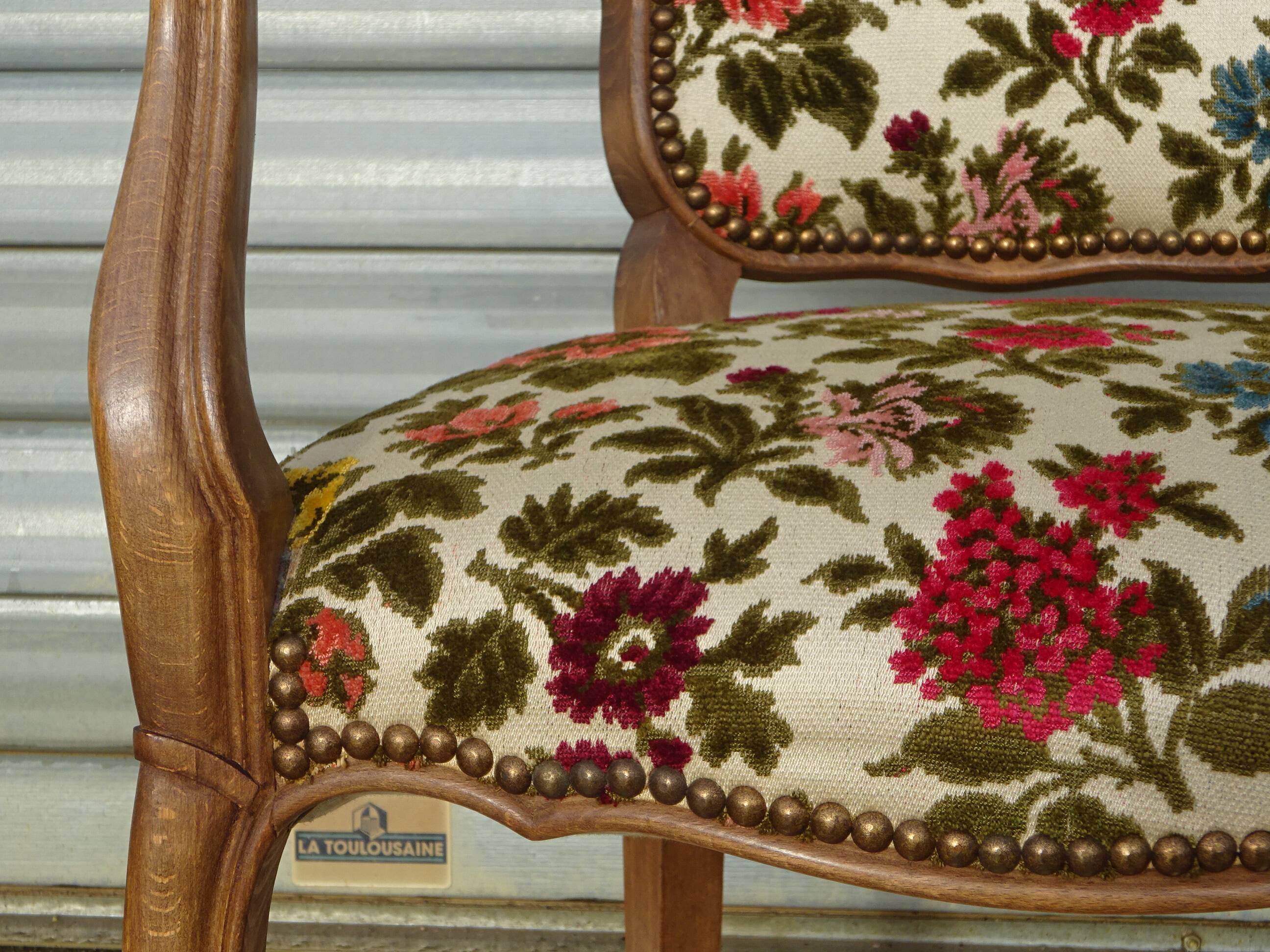 Convertible armchair with brocade fabric and floral patterns.