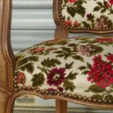 Convertible armchair with brocade fabric and floral patterns.