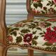 Convertible armchair with brocade fabric and floral patterns.