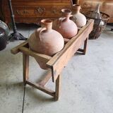 Old wooden jar holder with 3 clay jars