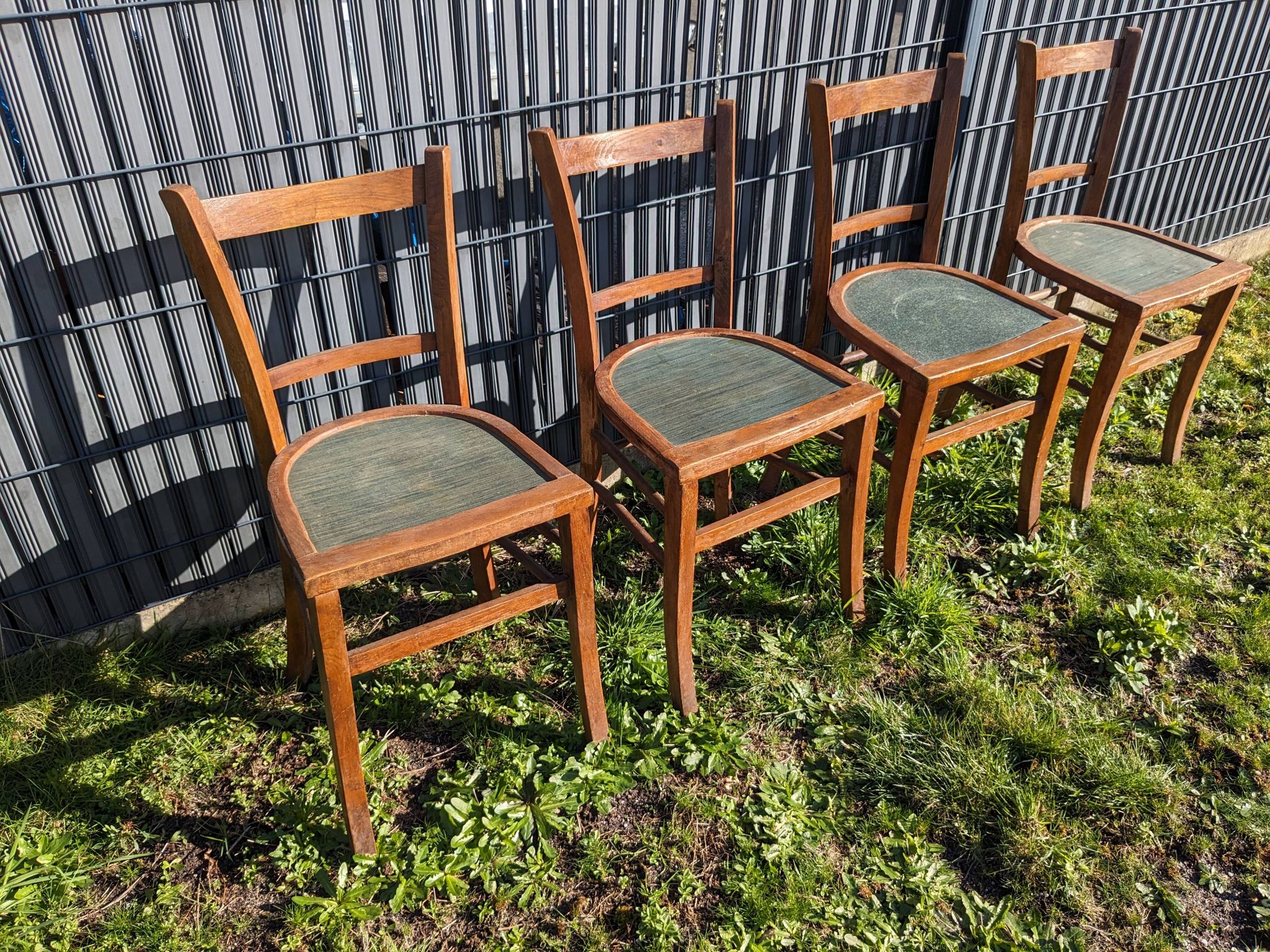 Set of four wooden bistro chairs, green seat, mid-20th century.
