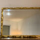 Miroir biseauté baroque aux fleurs sculptées et dorées