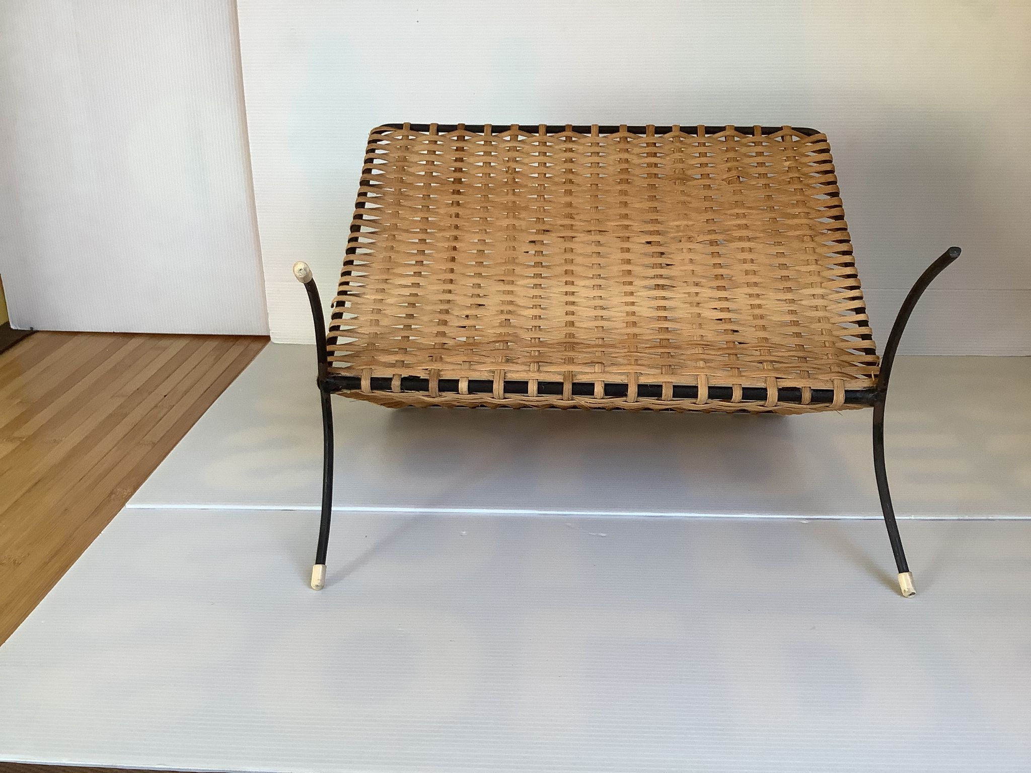 Old magazine rack in straw and black metal