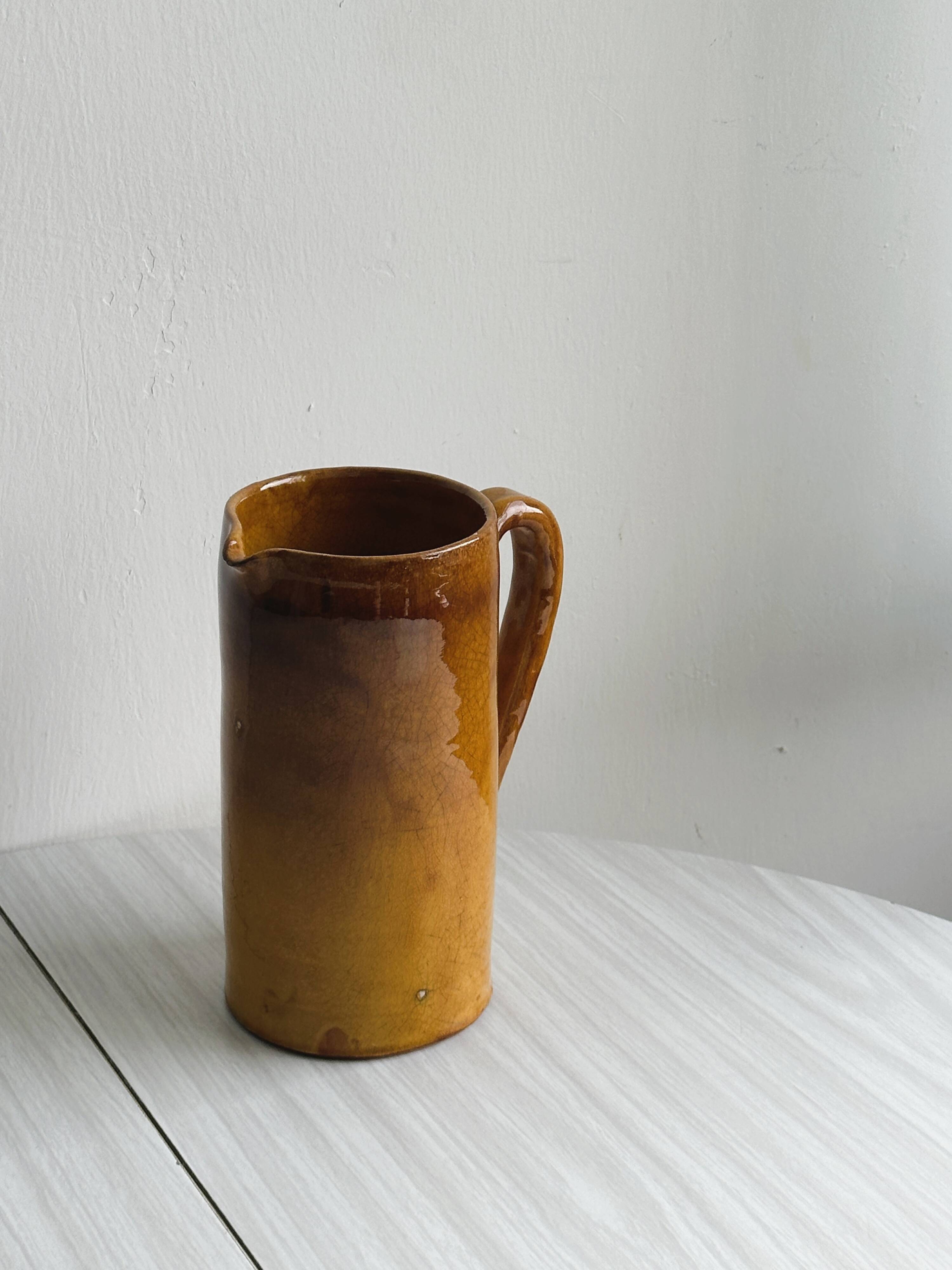 Vintage enameled ceramic watering can vase - retro mustard yellow pot.