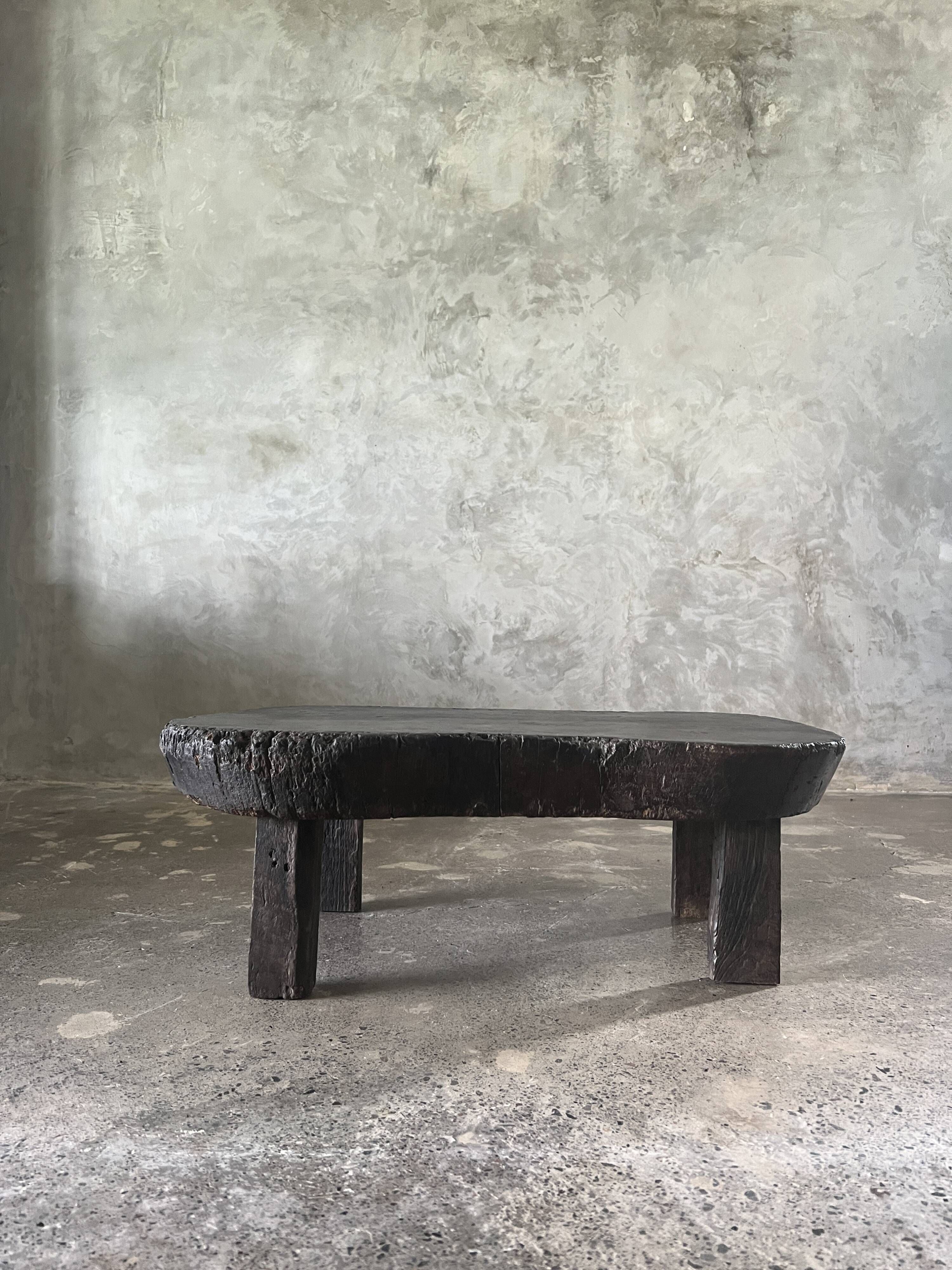 Small old Asian wooden coffee table in Japanese style, kidney-shaped top