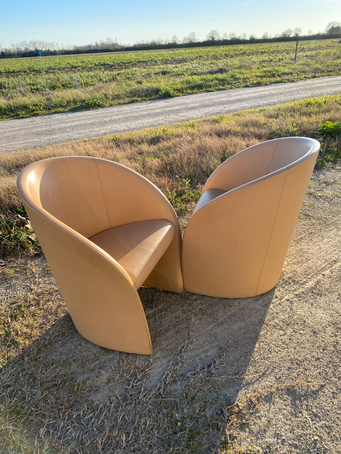 Pair of designer leather armchairs