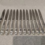 12 silver-plated dessert knives by Platil, rocaille style