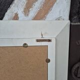 Oval mirror with a distressed white frame