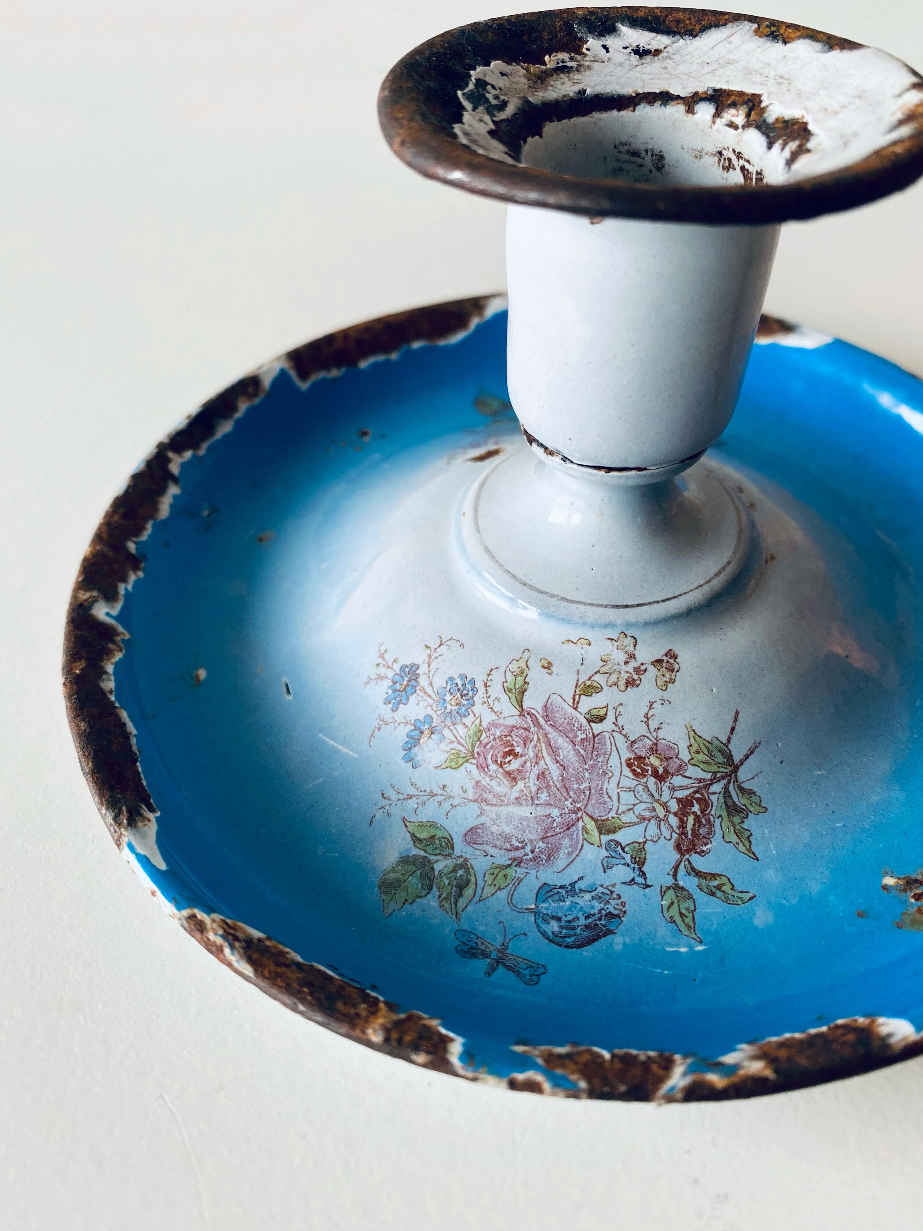 Old enamelled metal candlestick