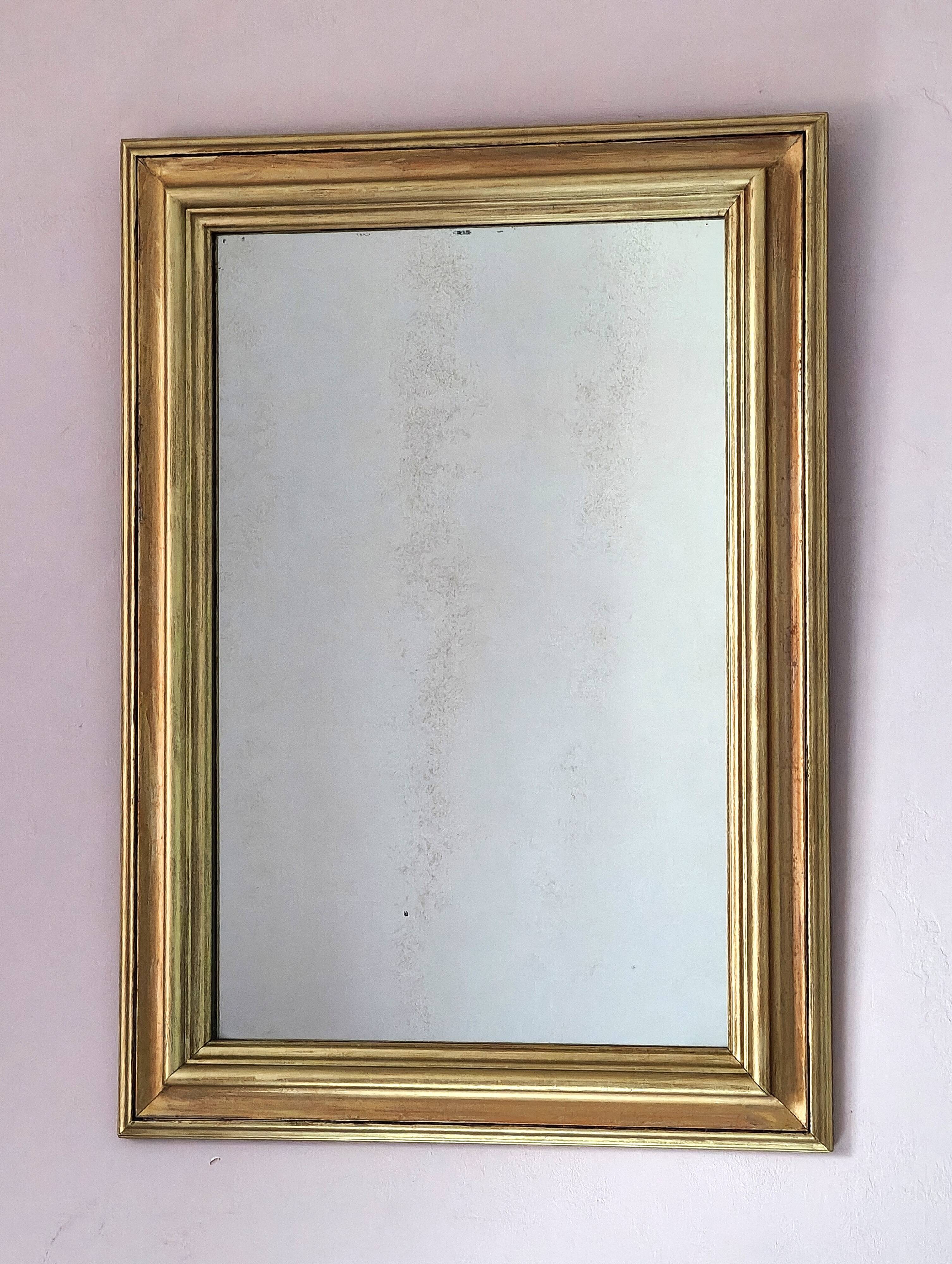 Miroir ancien en bois doré et cuivré