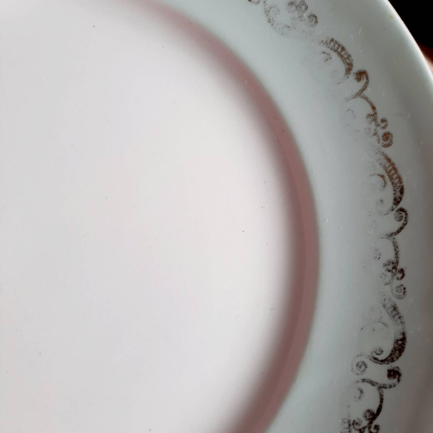 Old mismatched earthenware dinner plates accompanied by a deep dish