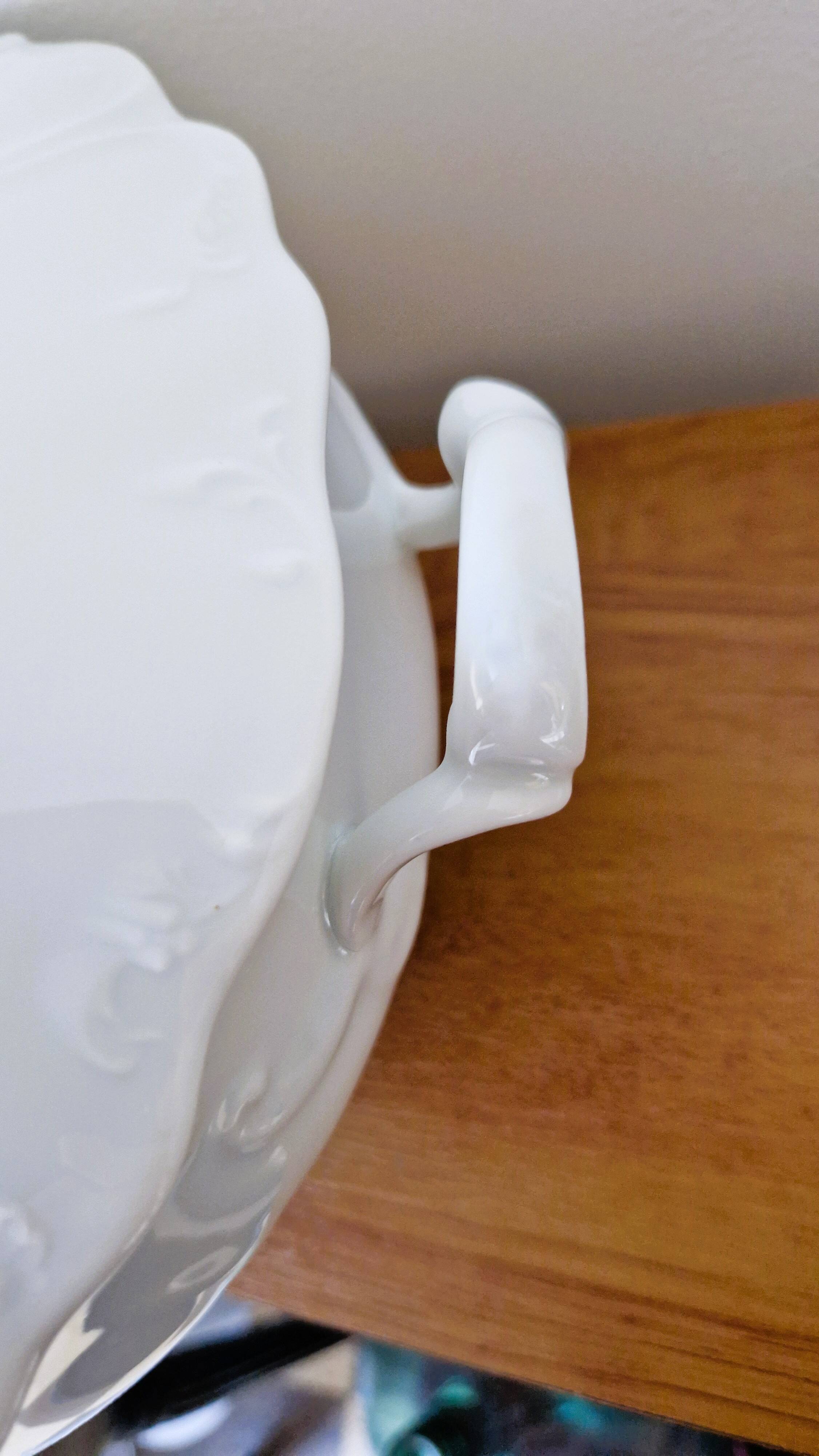 White porcelain soup tureen from Limoges with a vegetal scroll design.