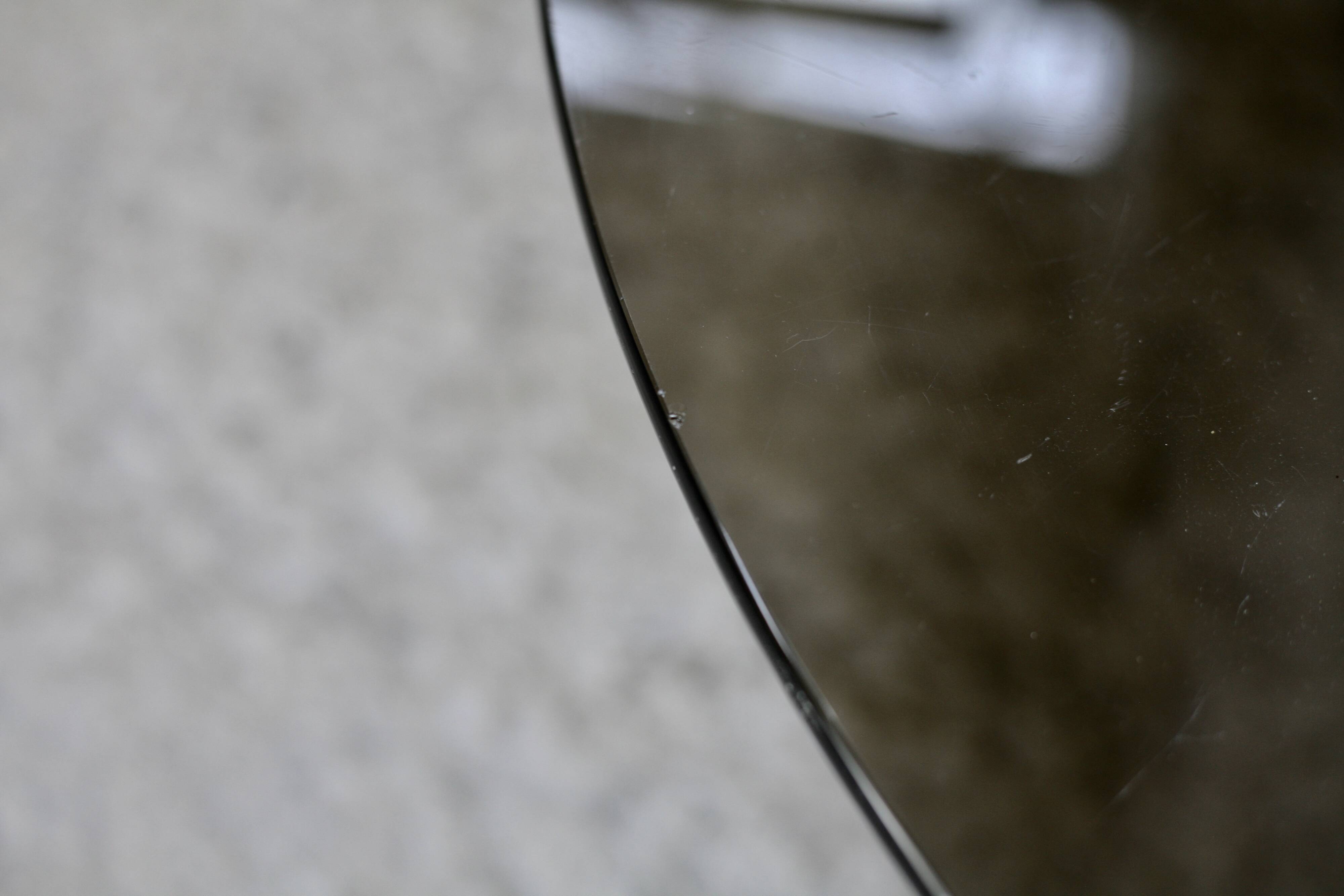 Coffee table with steel base and smoked glass slab. Circa 197