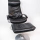 Easy chair with stool upholstered with black leather of Danish design, 1970s