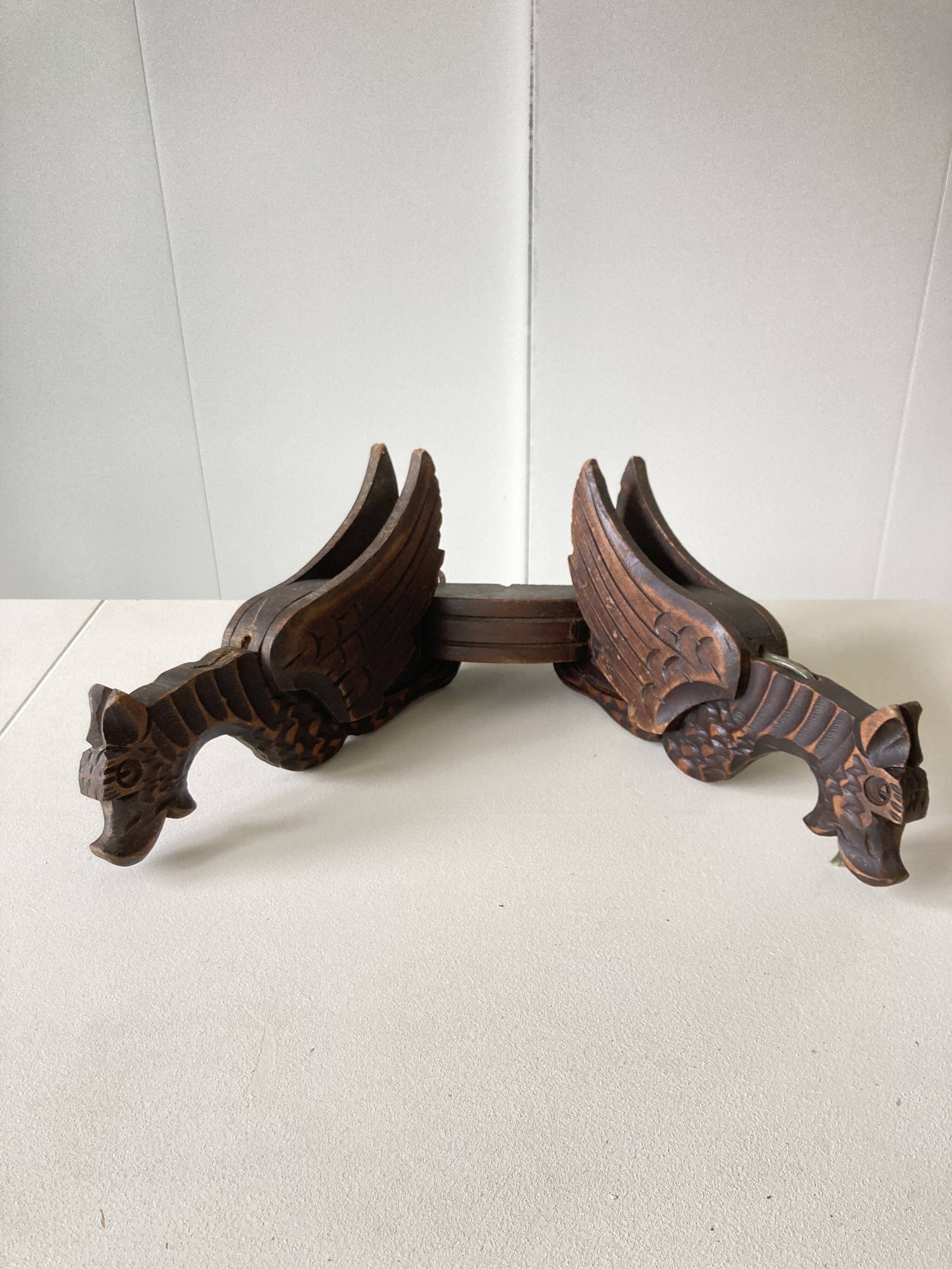 Pair of winged dragon sconces in carved wood