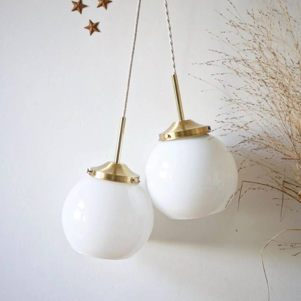 A pair of white opaline and brass suspensions.