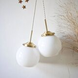 A pair of white opaline and brass suspensions.