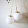 A pair of white opaline and brass suspensions.