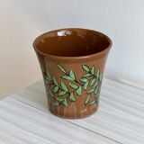 Cache-pot en céramique marron avec motif de feuillage vert peint à la main.