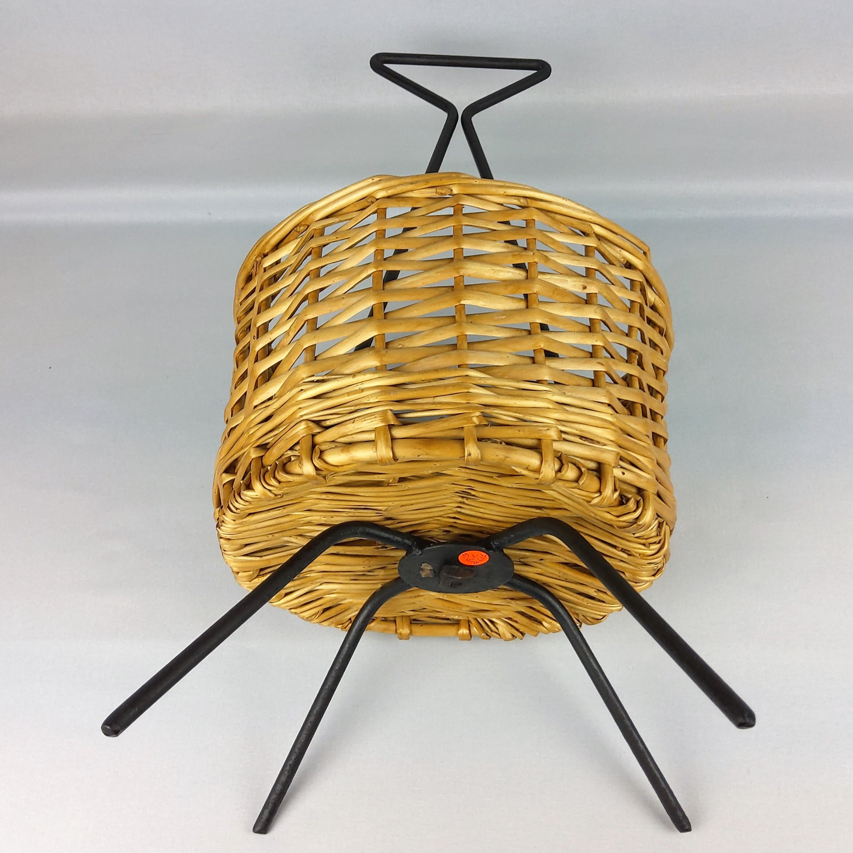 Black metal rattan trash can on 1960