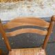 2 solid light wood straw-seated chairs