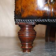 Victorian Chesterfield leather upholstered canapé with feather cushions.