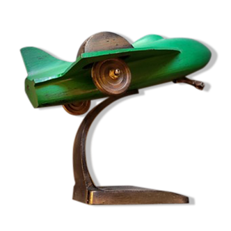 Metal aircraft on wooden base