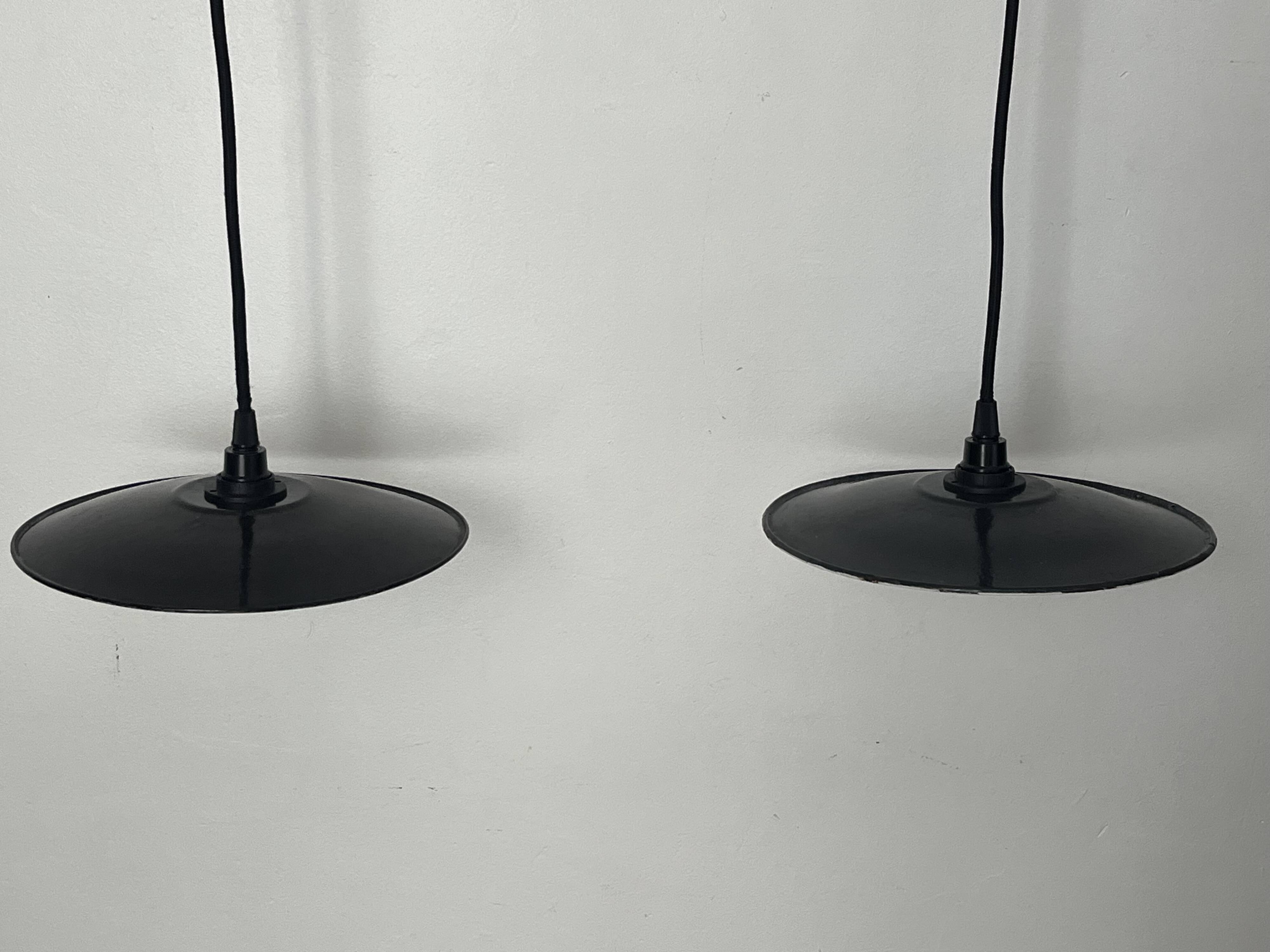 Pair of black enamelled metal bowls