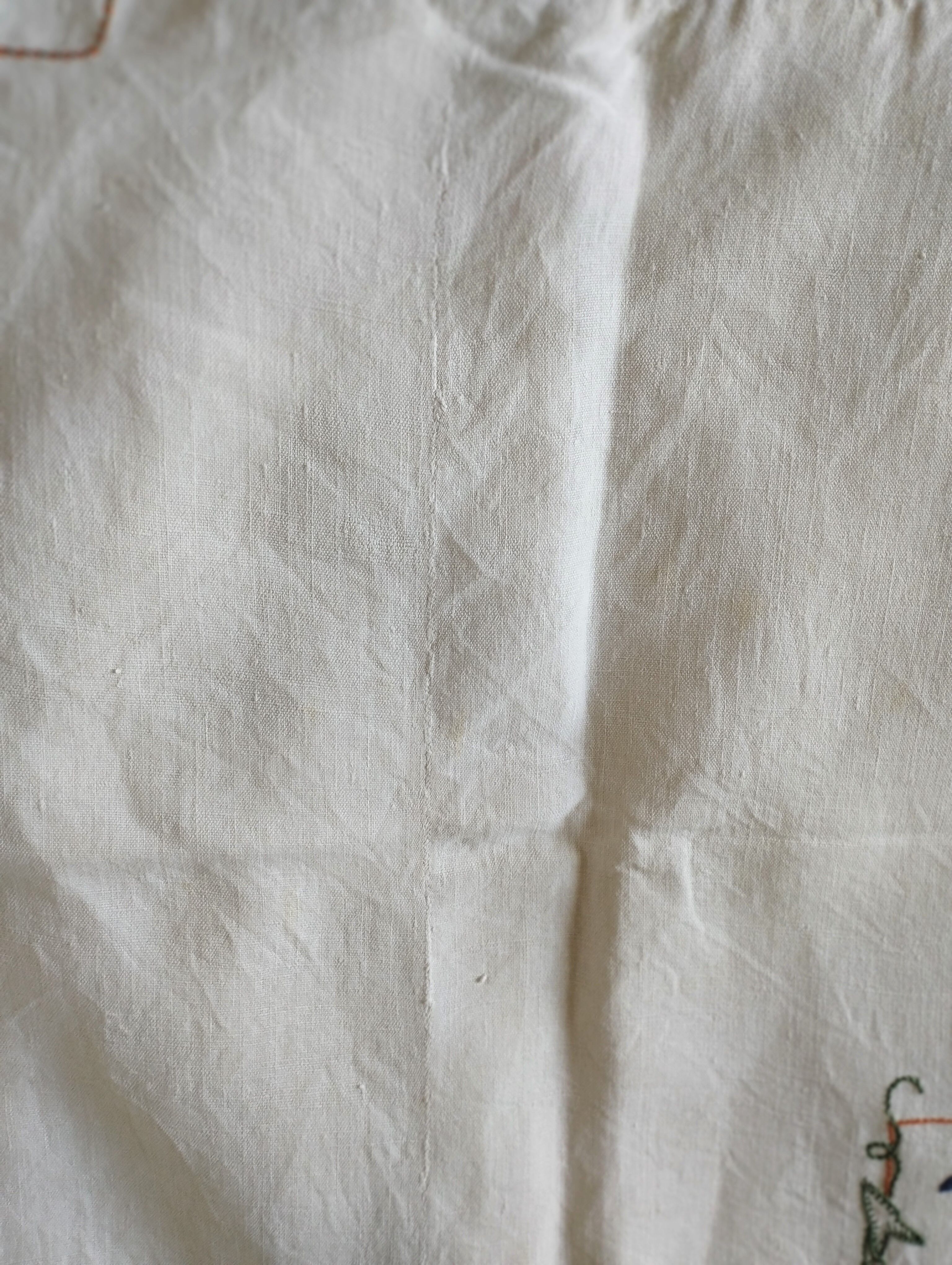 Antique linen tablecloth embroidered with flowers